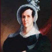 Painting of Elizabeth Taber - woman with dark hair in an up-do. She has on a dark dress with a white collar and a light-color bonnet with a bow. She has her hands crossed in front of her.