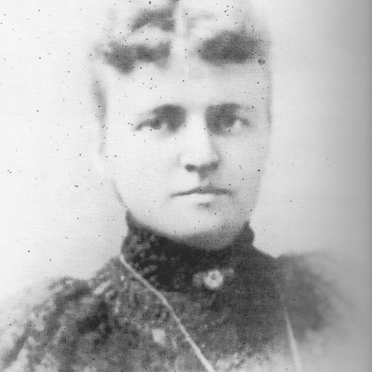 Photograph of Marian Shaw Smith - a woman with light hair pulled in a bun above her head and a black dress with collar