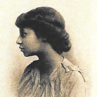 Yearbook Photograph Of Carrie E. Lee, Class Of 1917 - Bust Of Young Woman, Face In Profile Turned Towards Her Right. Woman Has Her Dark Hair In An Up-do And Is Wearing A Light-colored Top.