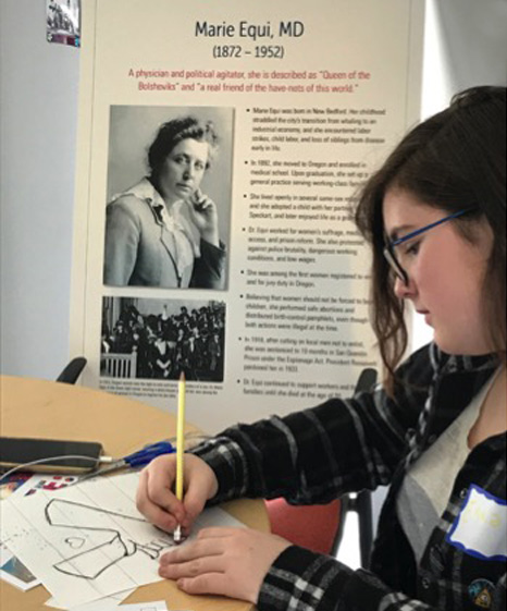 young woman working on a drawing for re-ignite