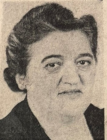 A Photograph Of Bertha Cohen, She Has Dark Hair With Grey Streaks And Is Looking At The Camera