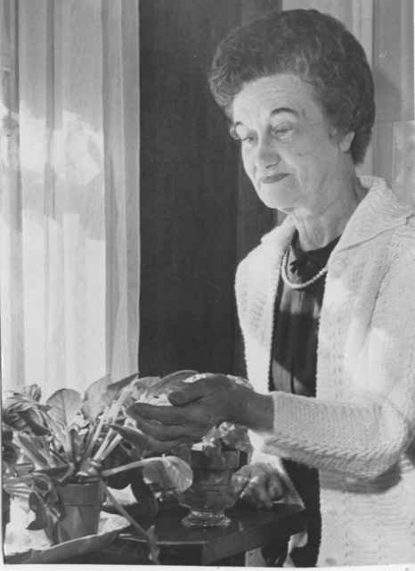 Photograph Of Flora B. Peirce Looking At Plant
